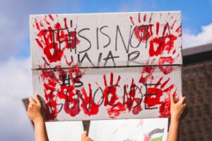 a person holding a sign that says this is not a war